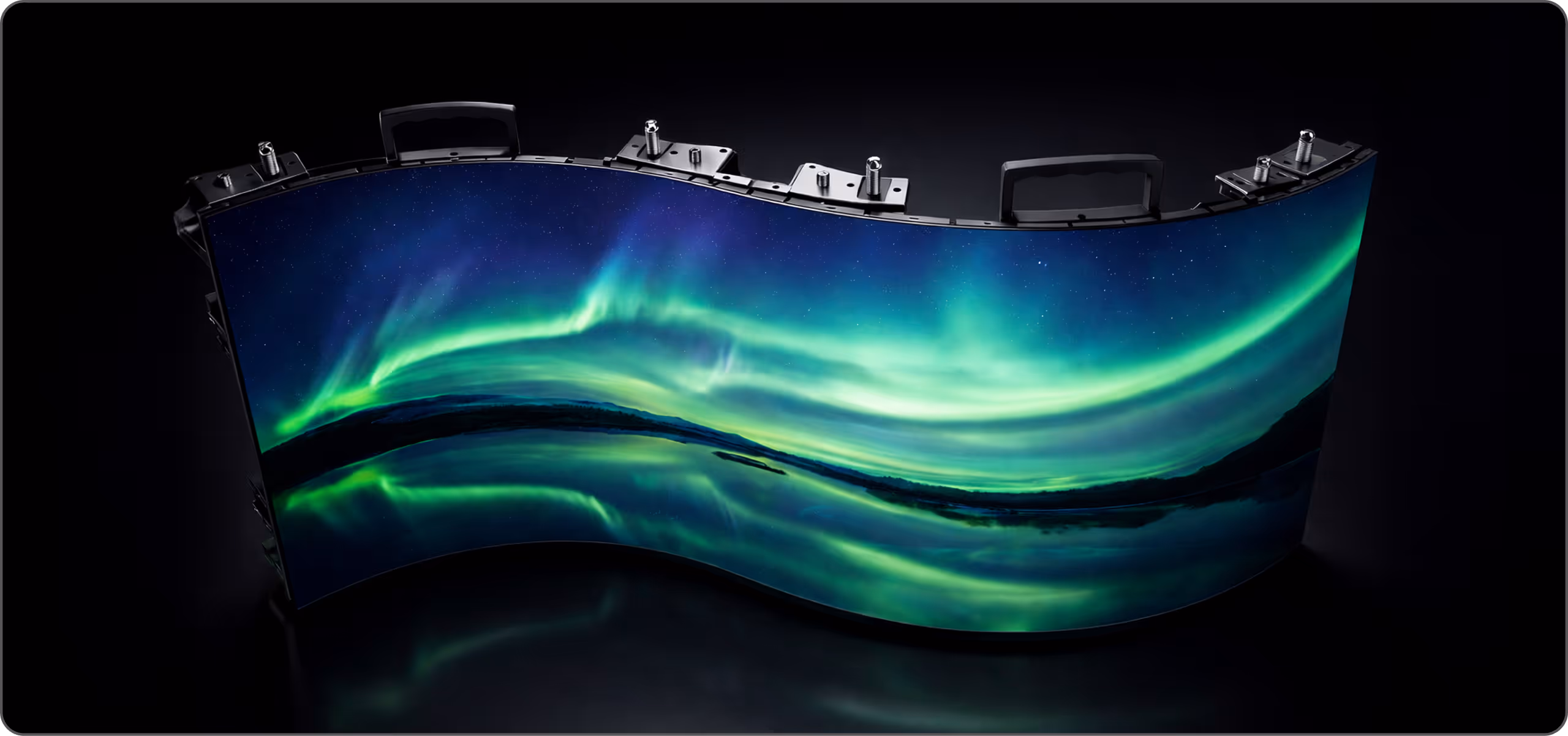 Large LED screen displaying a colorful abstract swirl pattern mounted on a black modular panel system against a dark background.
