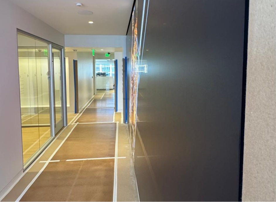 A luxury environment demands more than simply placing a display on a wall. At Dimensional Fund Advisors’ Santa Monica office, the lobby was designed with the refinement of a gallery, but its narrow proportions created a unique challenge. The digital artwork would be experienced from just a few feet away, making extraordinary clarity and seamless integration essential. The challenge was to introduce a large-scale digital experience without disrupting the sophistication of the architecture around it.
