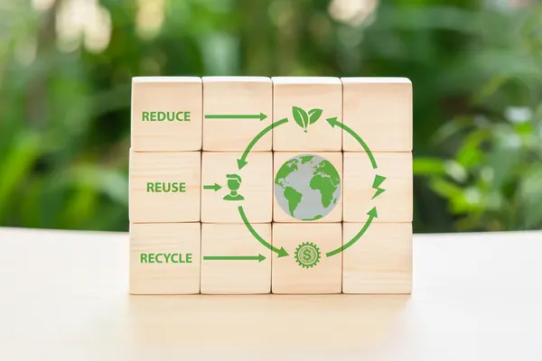 Wooden blocks showing reduce reuse recycle sustainability concept.