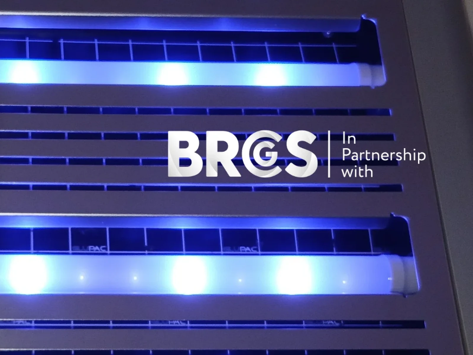 Insect light trap with Opti-Catch LED tubes glowing blue and BRGS partnership branding.