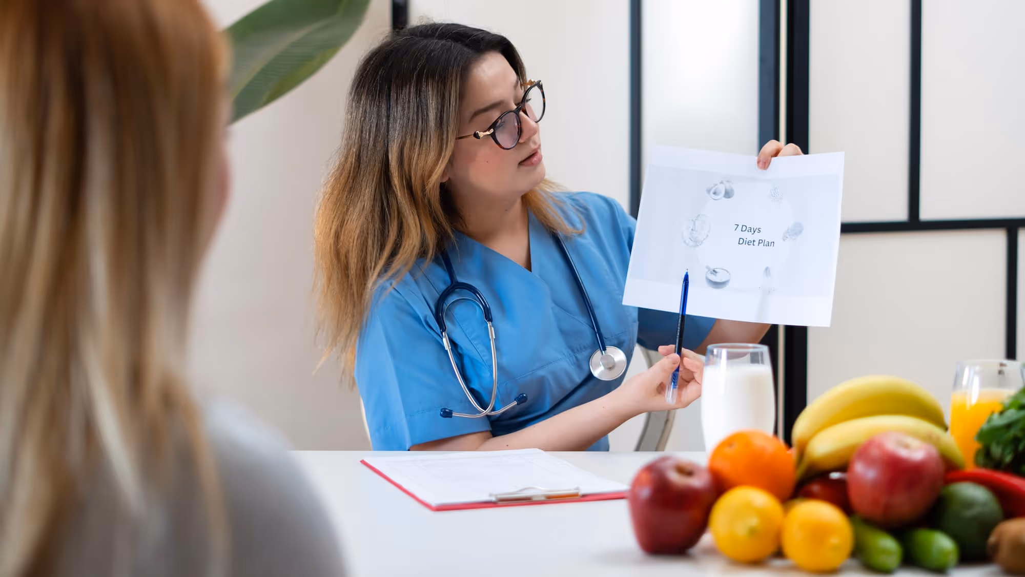 A physician showing a healthy eating plan.