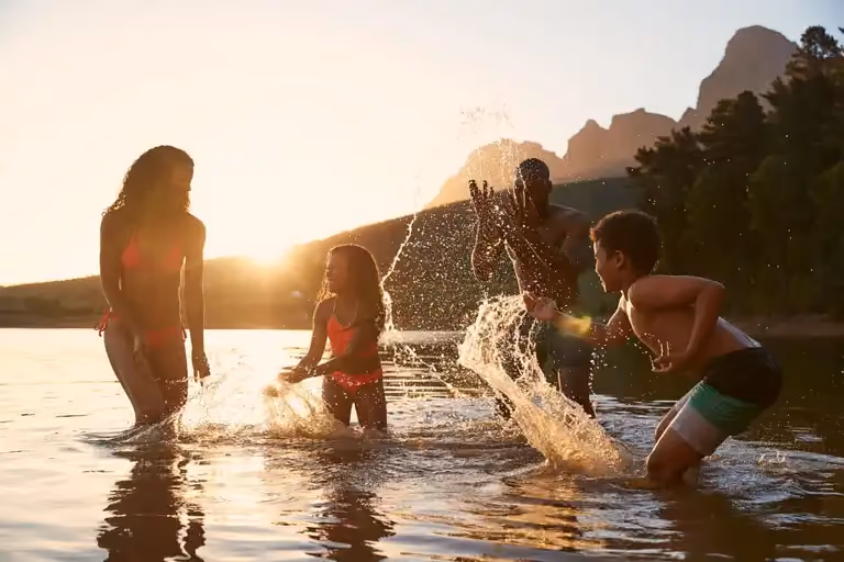 A family having fun in the shore of a beach.