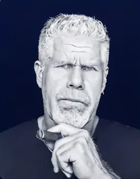Man with silver hair and beard in a thoughtful pose, representing creative talent
