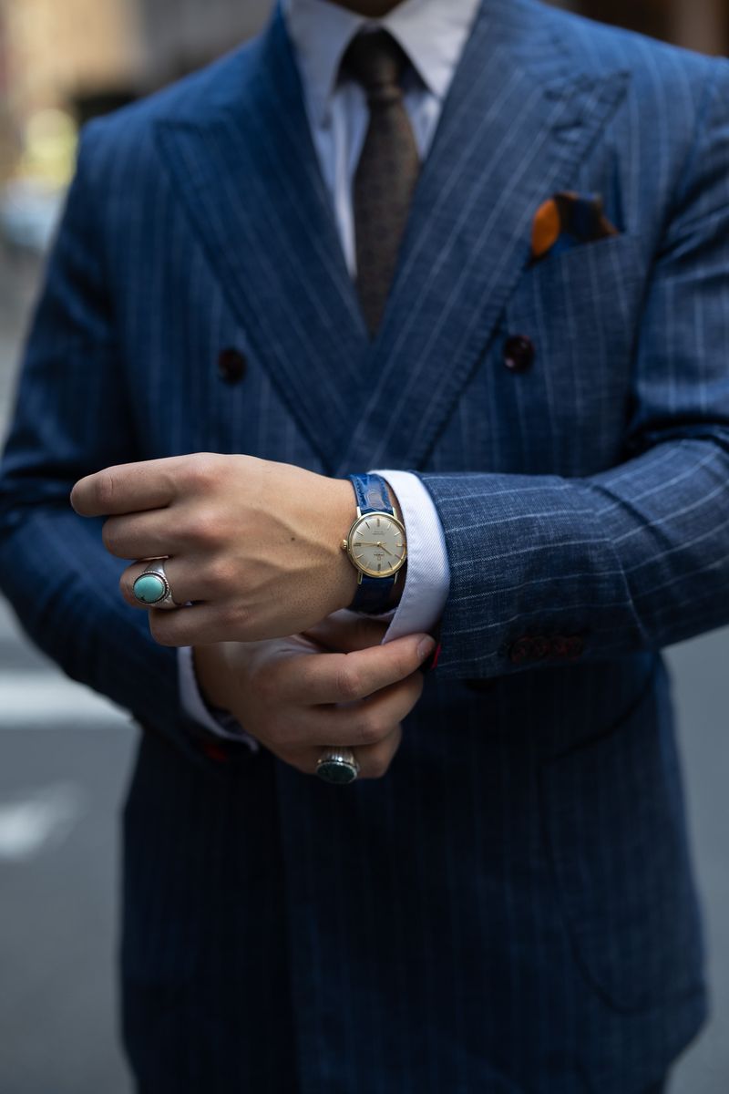 Cuff detail of a blue pinstripe bespoke suit with vintage watch