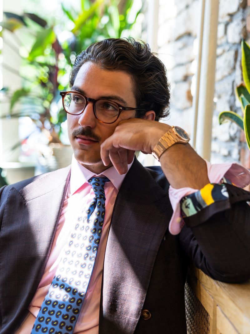 Glen plaid jacket, pink shirt, and paisley tie &mdash; seated portrait