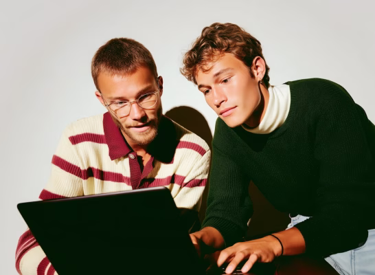 Two people discussing privacy policy on a laptop.