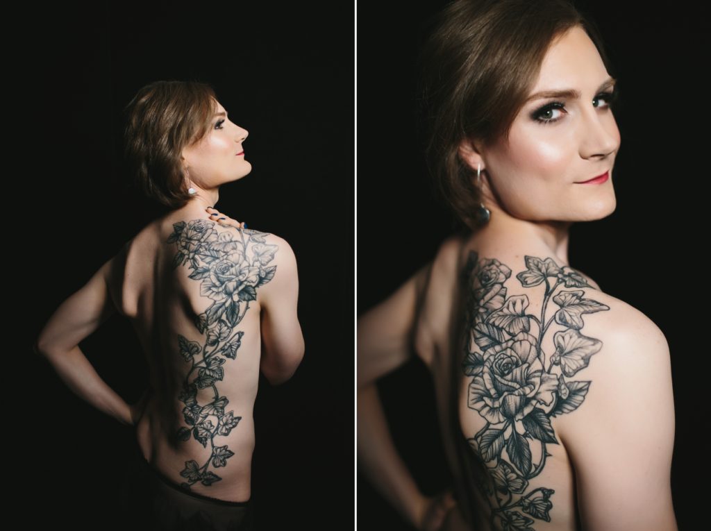 blonde woman topless showing off tattoo in front of a dark background; boudoir photography by Lindsay Hite