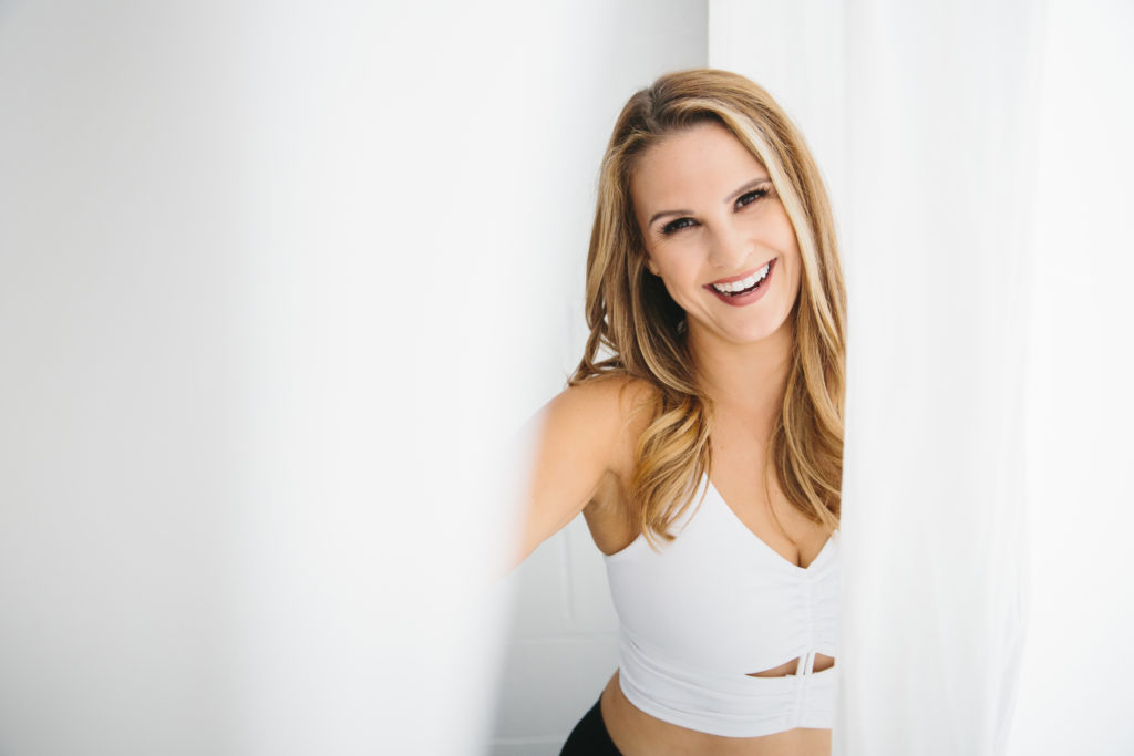 Woman smiling at camera, boudoir photography by Lindsay Hite