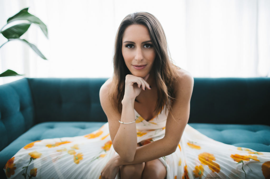 Woman in sundress on teal sofa, what do I wear, photography by Lindsay Hite