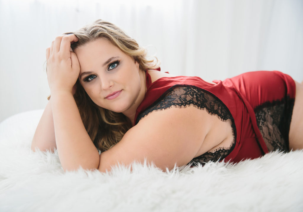 Woman in red and black lace silk pajamas on white bed, what do I wear, boudoir photography by Lindsay Hite