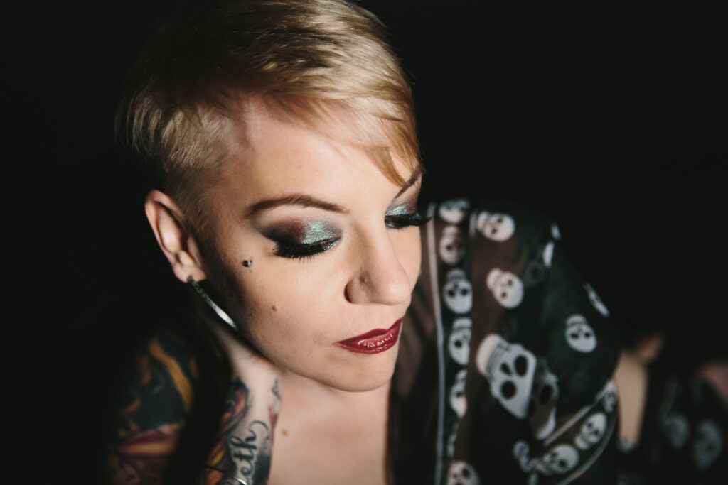 Blonde short-haired woman wearing skull shirt with glam hair and makeup; Photography by Lindsay Hite Hair and Makeup by Michelle DeVoe