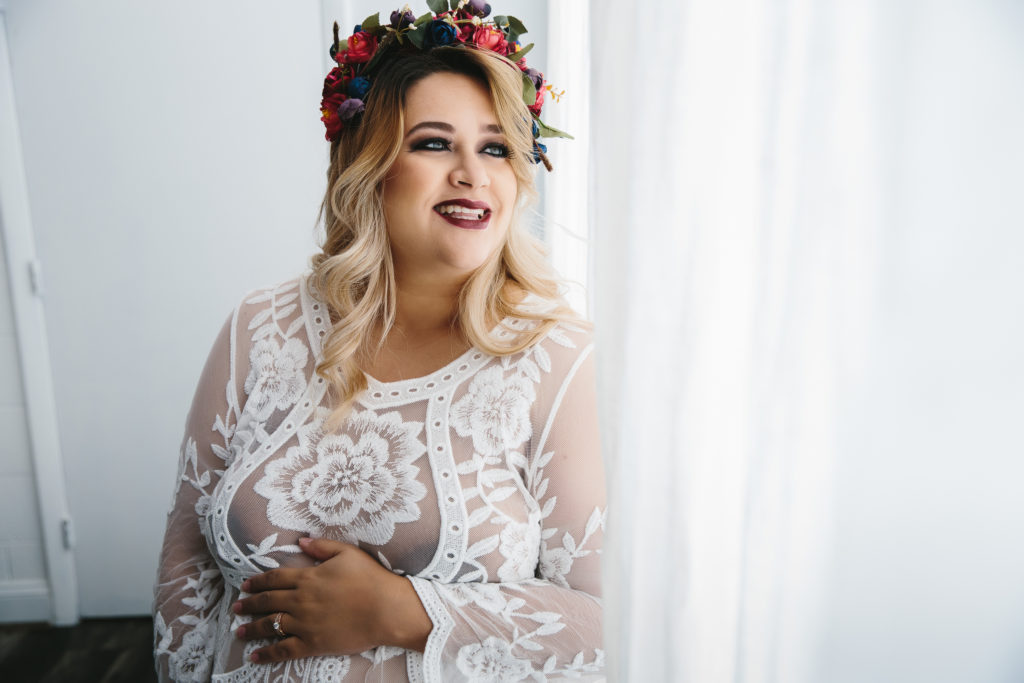 woman in white gown and flowers in her hair, hair and makeup by Michelle DeVoe, photography by Lindsay Hite
