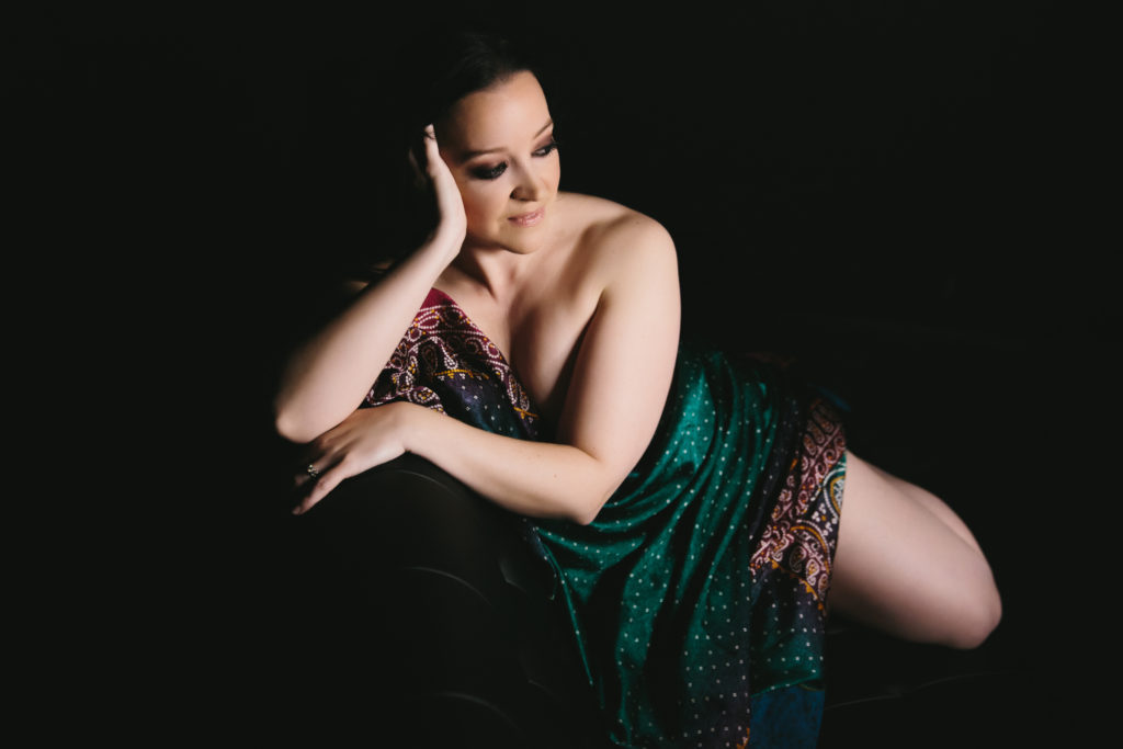 woman wrapped in textile with dark background, photography by Lindsay Hite