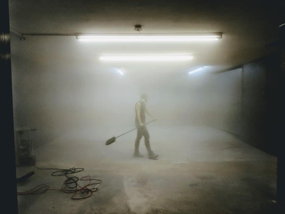 Boston-Area Luxury Photography Studio, woman with mask and broom and construction dust