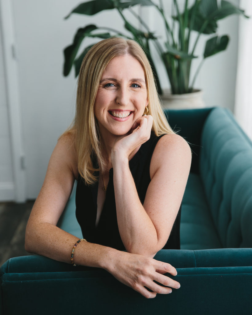 Boston-Area Luxury Photography Studio, Client Concierge, Catherine in black sleeveless top on teal sofa