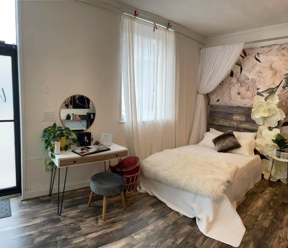 Boston-Area Luxury Photography Studio; Photography studio front room, Loft space with airy bed and table with wood floors