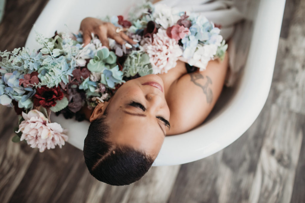 Woman in bathtub holding flowers; boudoir photography by Lindsay Hite - How to overcome imposter syndrome-- self-care