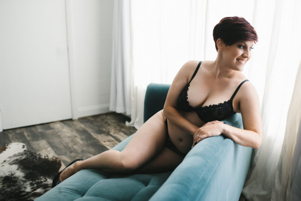 short haired woman in black lingerie on teal sofa: A Gift For Yourself: Boudoir Photography by Lindsay Hite