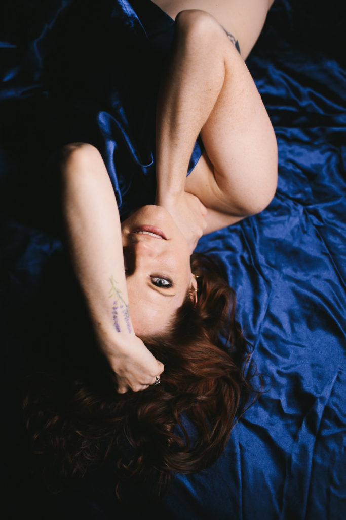 Woman in blue satin sheets, by Lindsay HIte