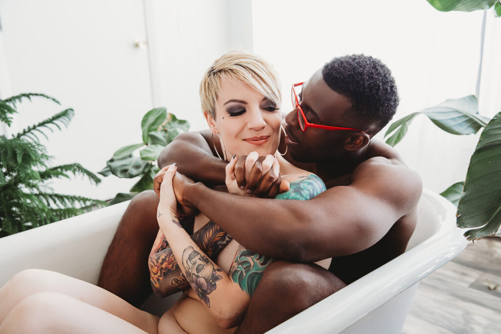 Portrait of a couple in a white garden bathtub. Decadent bathtub poses by Lindsay Hite.