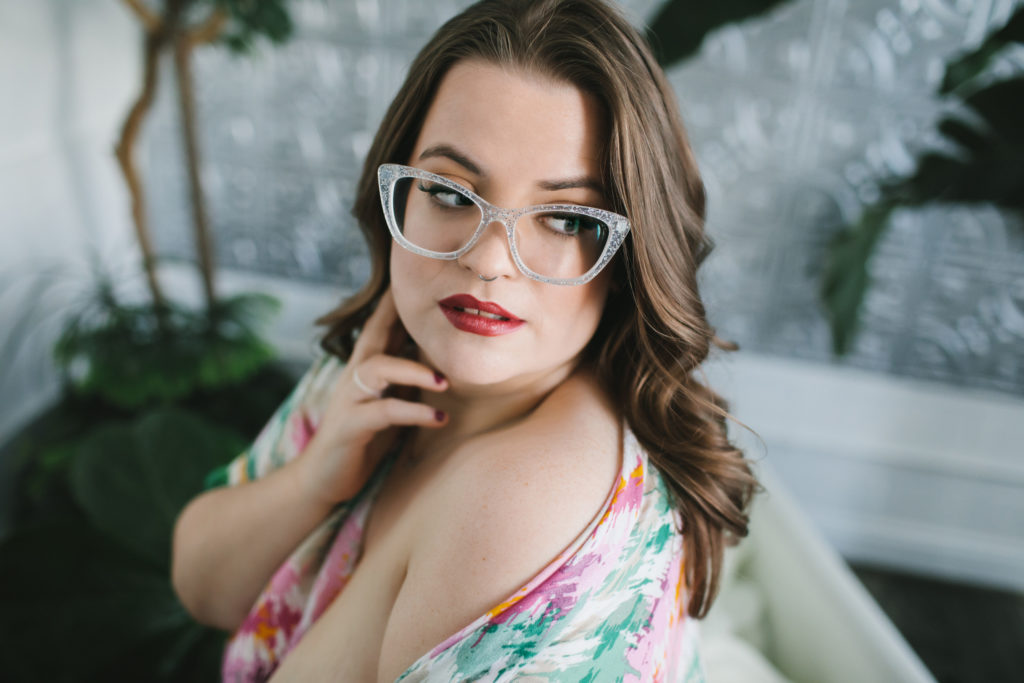 woman with floral top slipping off her shoulders; boudoir photography by Lindsay Hite