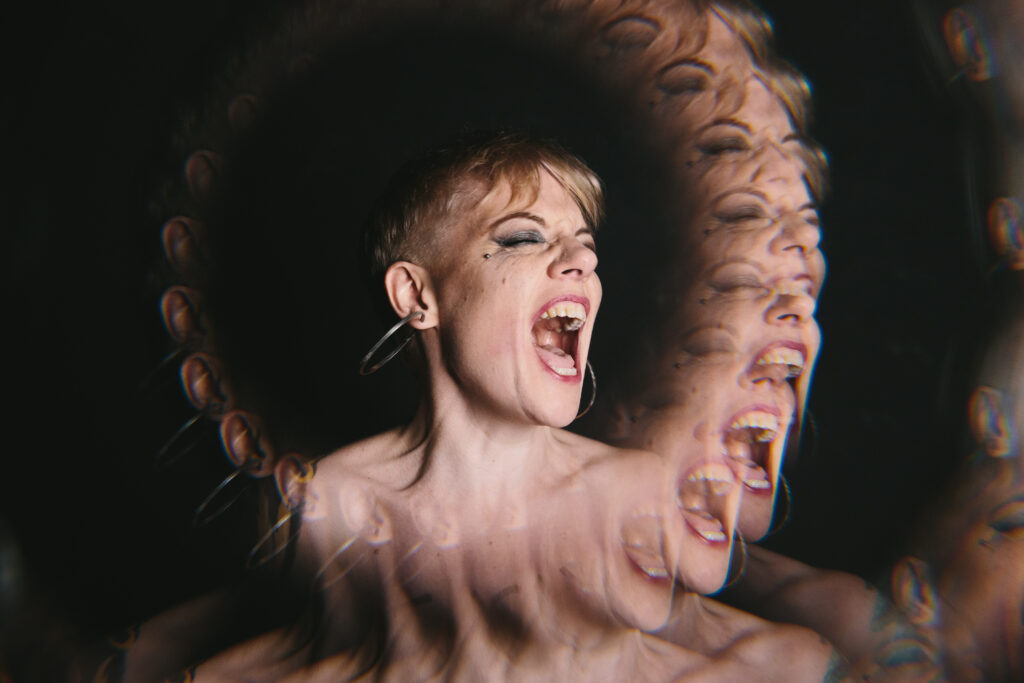 Artistically overlayed image of a woman screaming. Photography by Lindsay Hite.