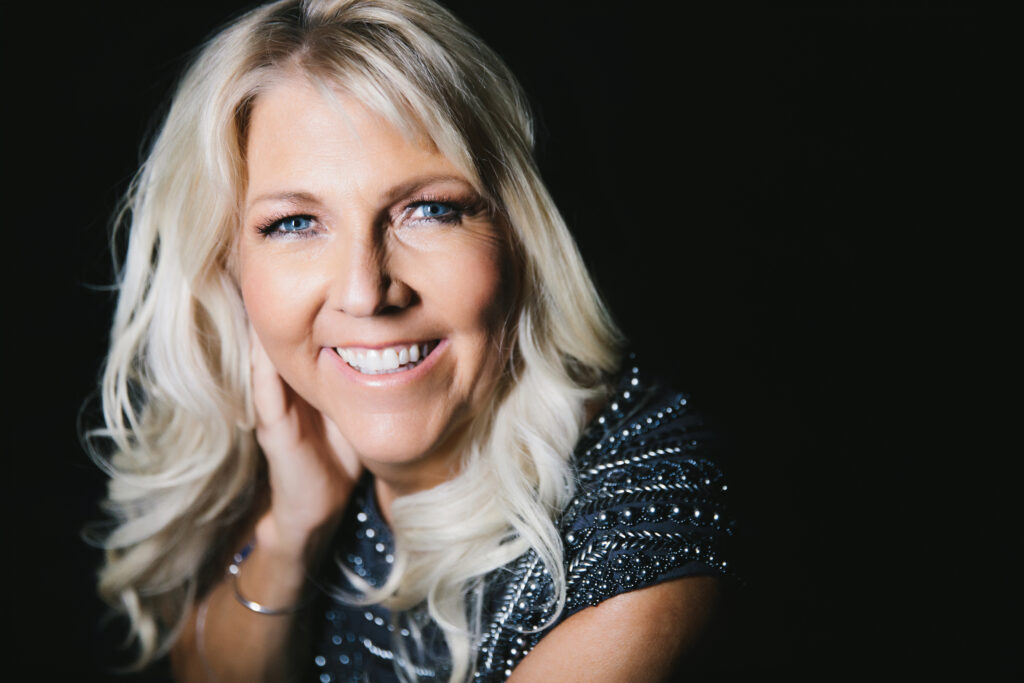 Woman in black dress with beaded embroidery, women over forty learns to overcome ageism.  Photography by Lindsay Hite