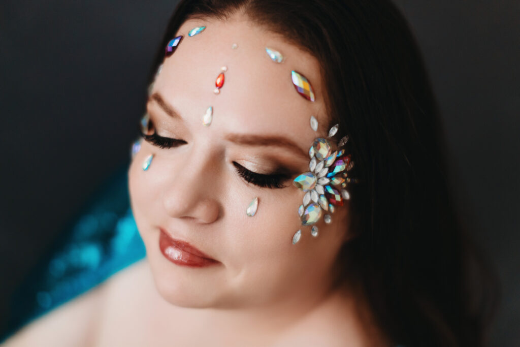 Woman with jewels on her face.