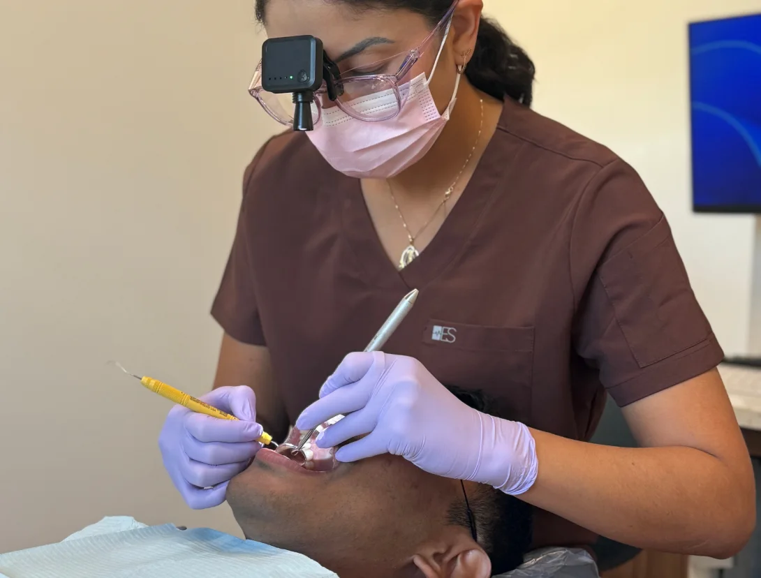Rinse Dental hygienist performing a professional dental cleaning