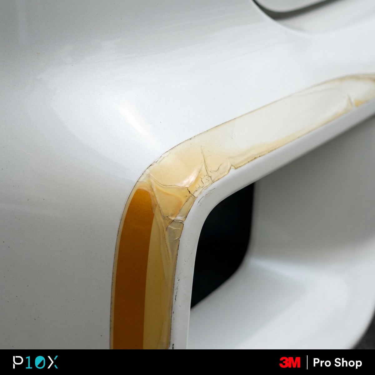 PPF yellowing in Malaysia showing an amber stripe at the cut edge of a white car's bumper.