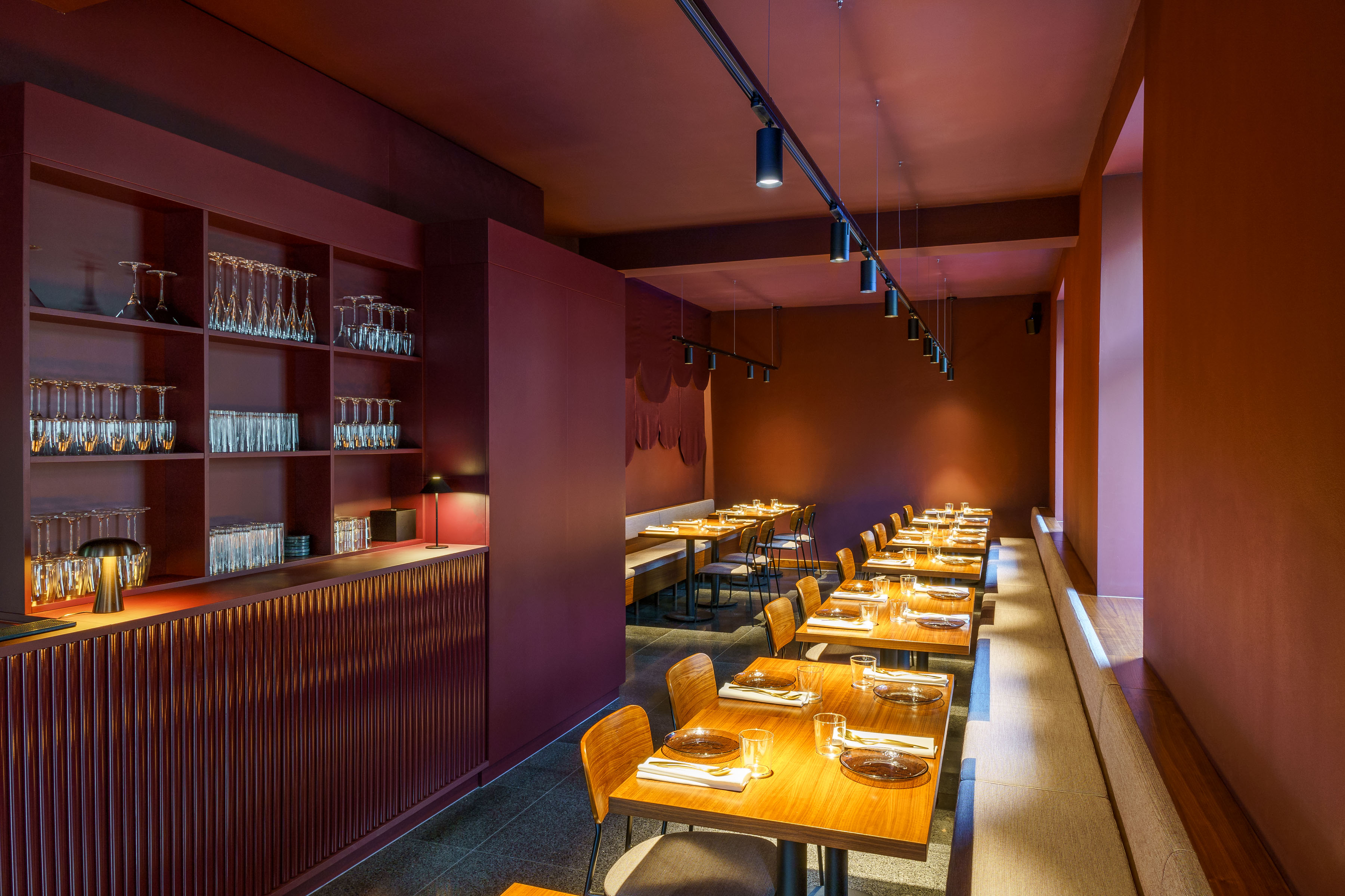 The dining room at Umbra seen from the bar, tables laid for the evening