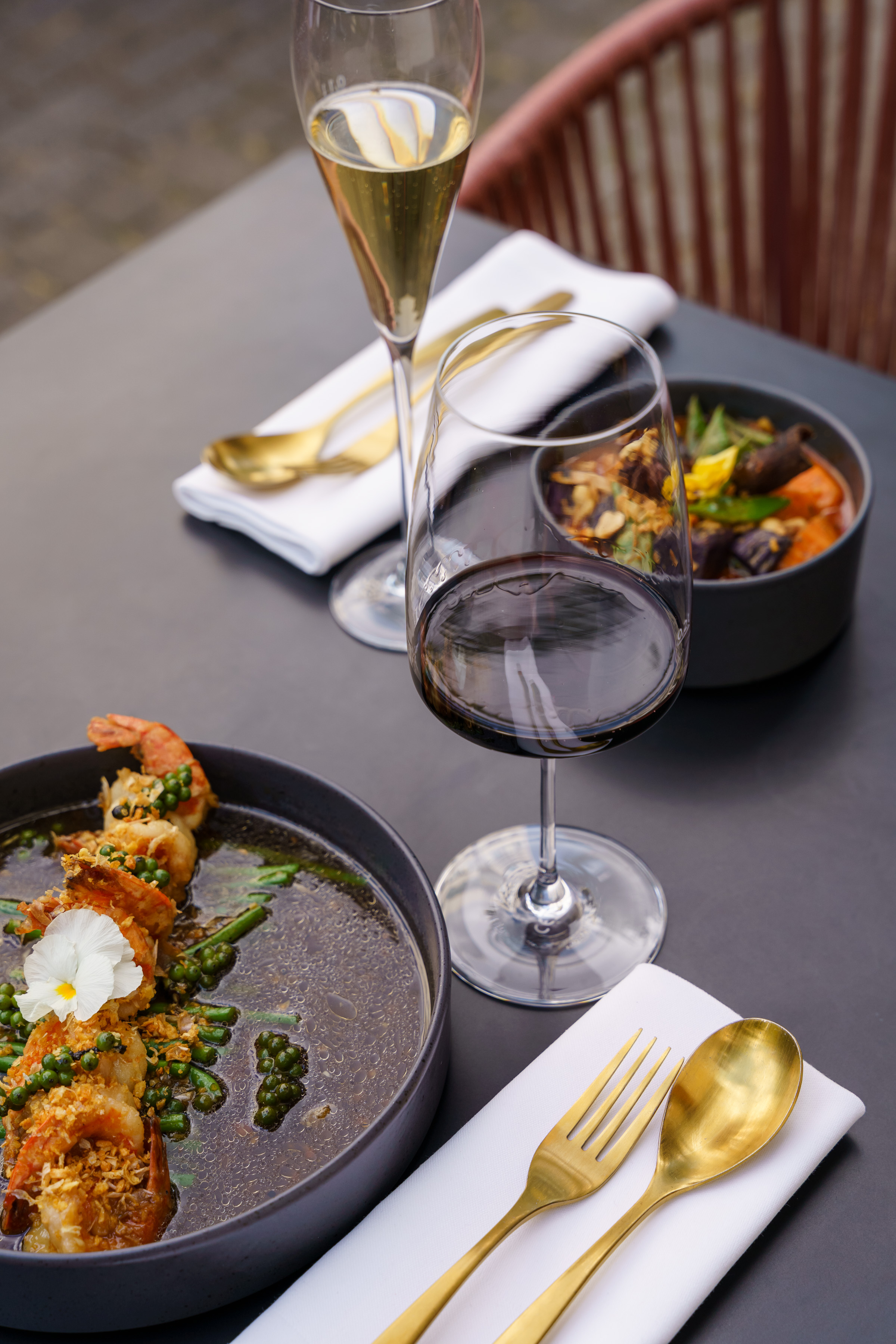 A table for two at Umbra with wine, sparkling wine and shared Thai dishes