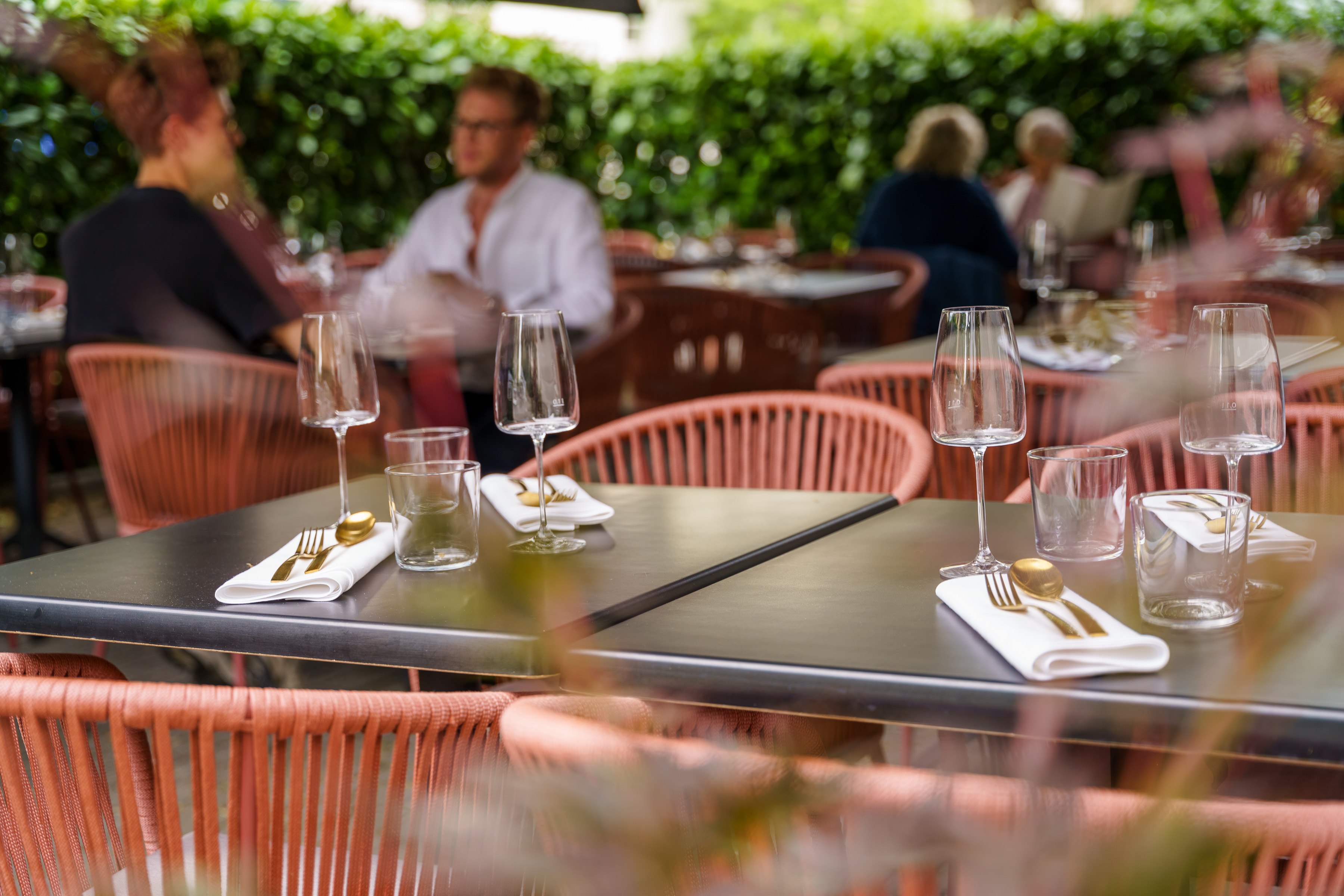 Guests dining together on the terrace at Umbra