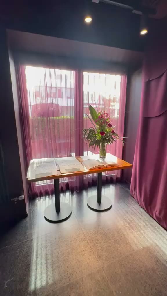 A table by the window at Umbra, set with flowers