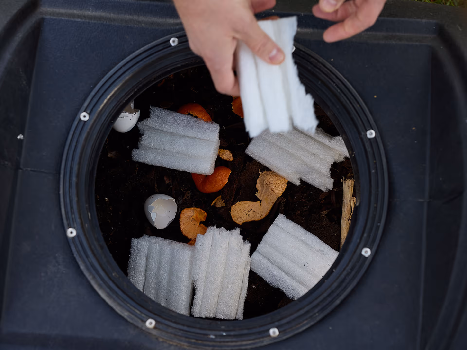 Composting green cell foam in home compost bin.