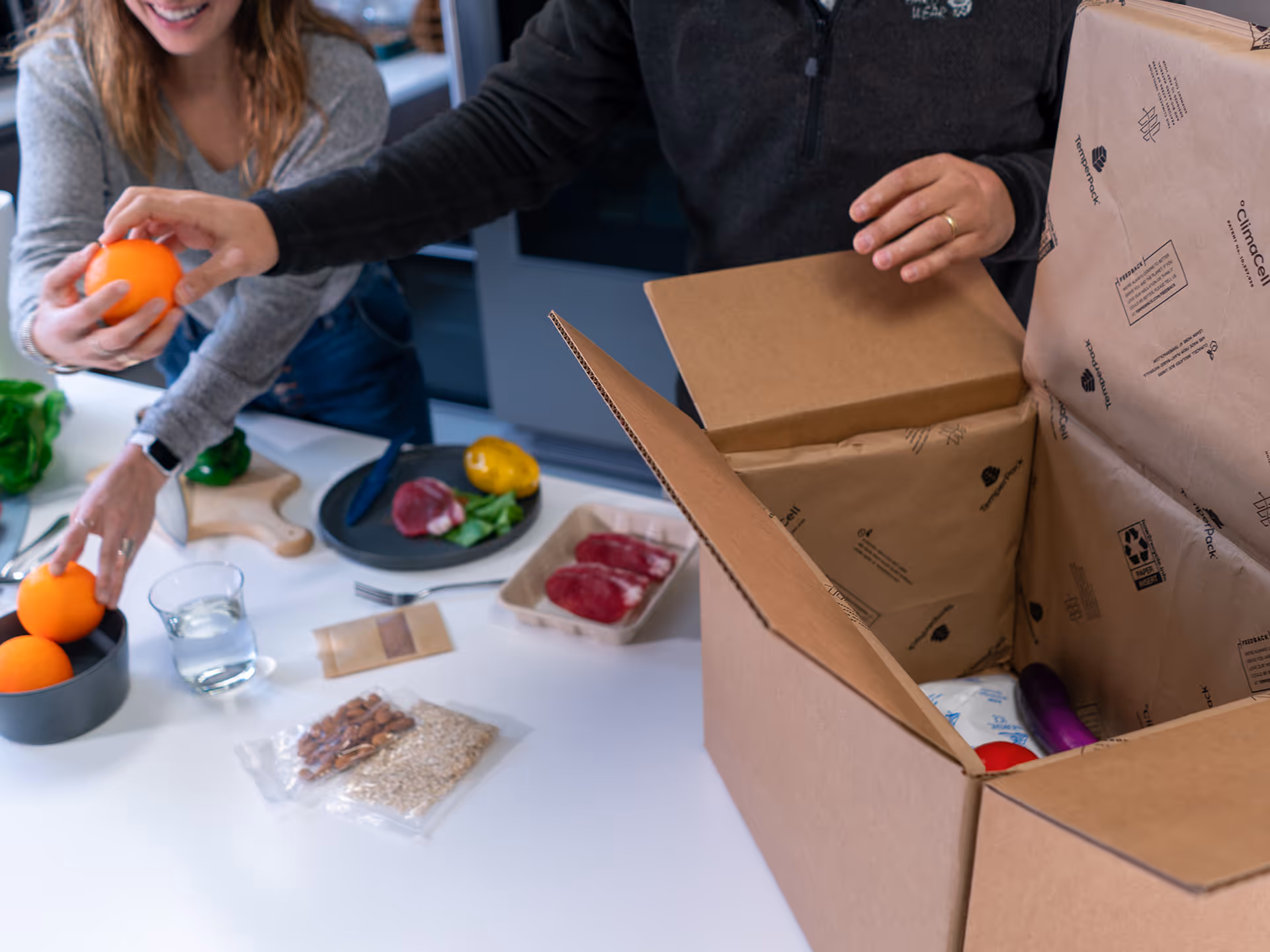 Couple unboxes their meal kit lined with ClimaCell. 