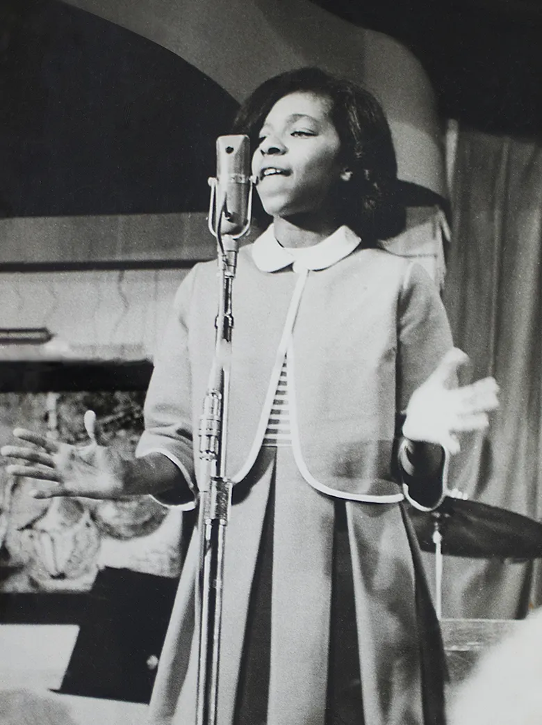 Young Natalie singing on stage