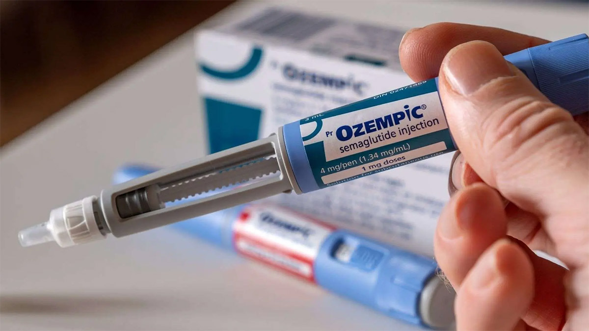 A man holding an ozempic injection pen in his hand.