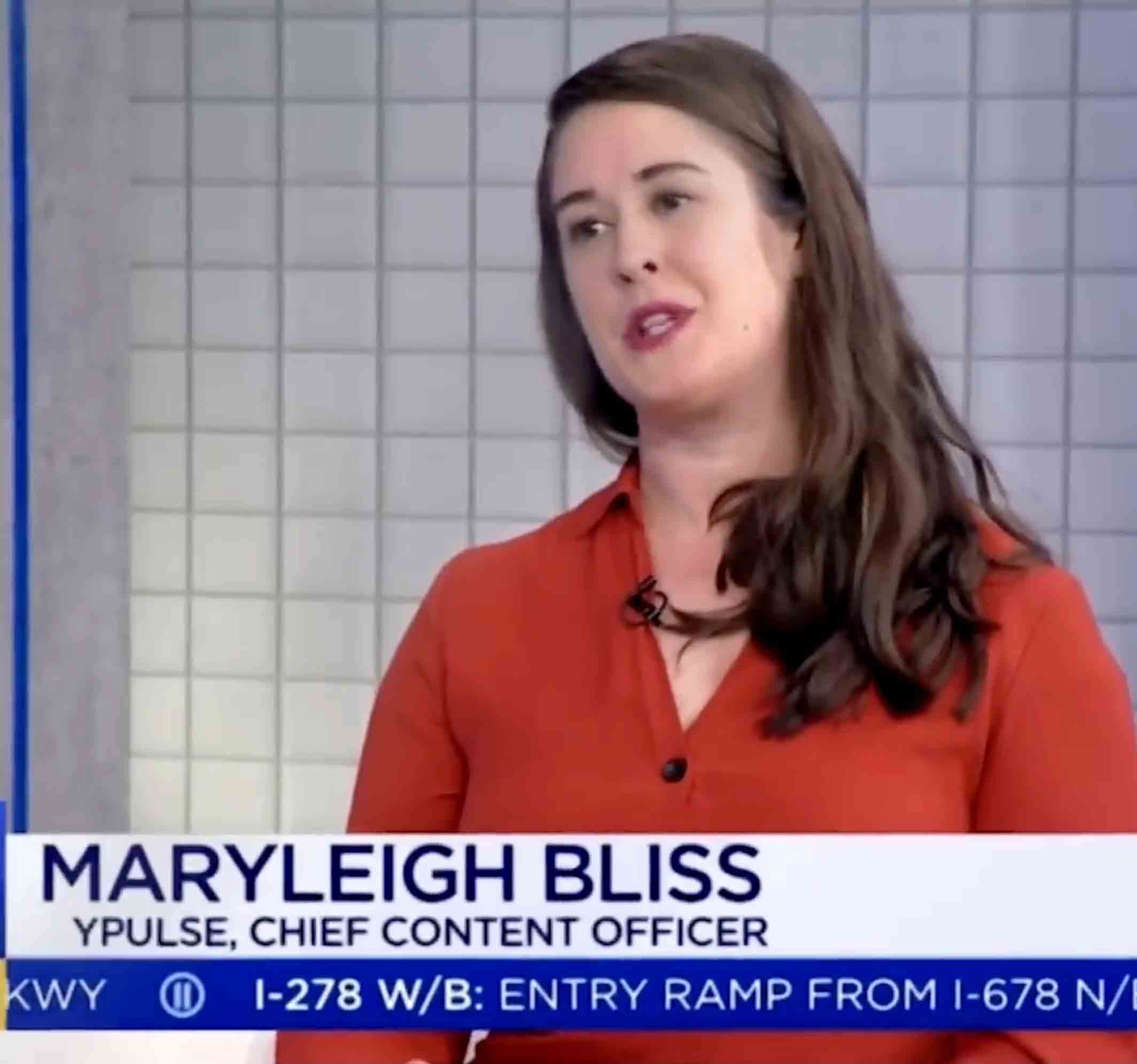 Maryleigh Bliss, YPulse Chief Content Officer, speaking in an interview with a tiled background.