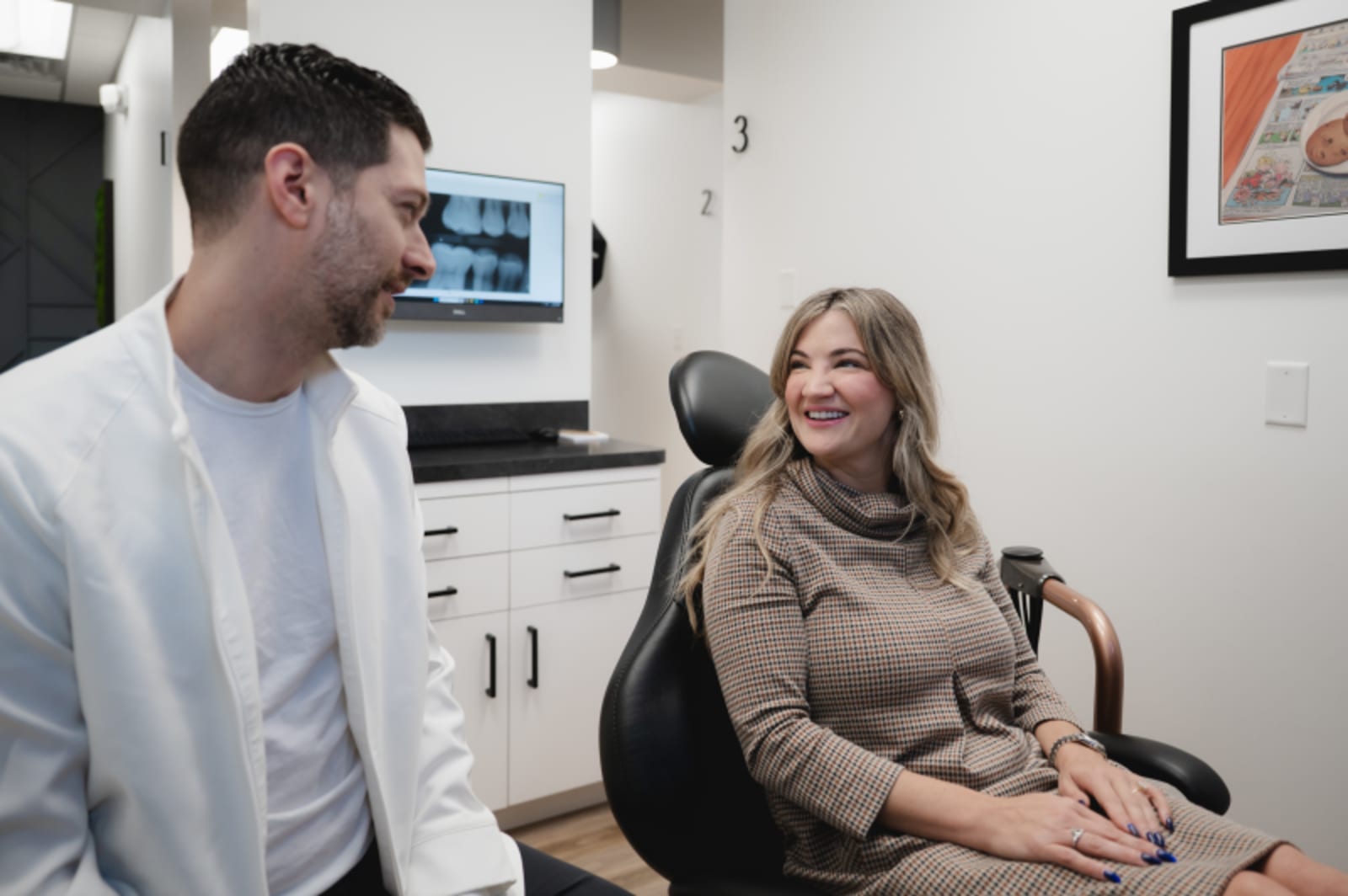 Dentist consulting with patient about treatment options in clinical setting