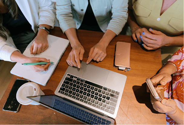 women sitting around a computer