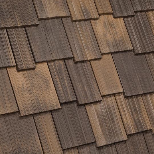 Close-up of blue and gray asphalt shingles arranged in a layered pattern.