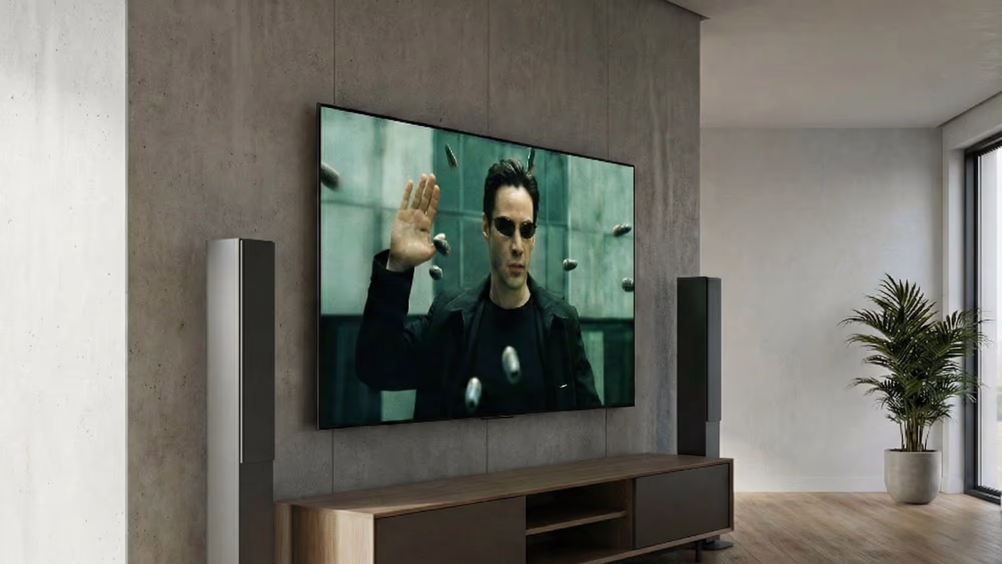 Wall-mounted flat-screen TV displaying a scene from The Matrix with Neo stopping bullets mid-air in a modern living room.