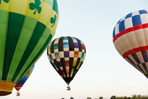 A group of hot air balloons flying in the sky