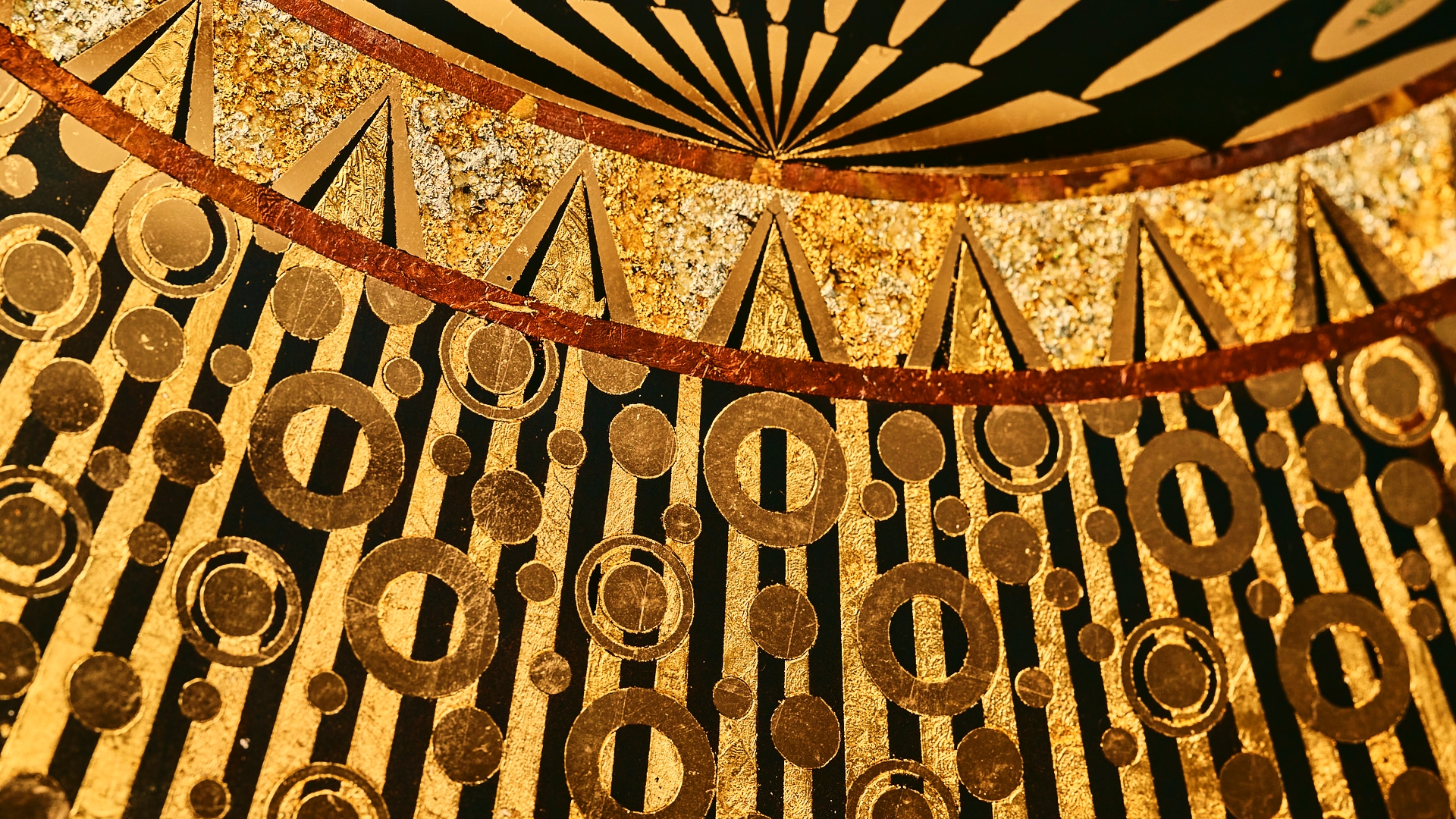 Close-up of SOLEIL's hand-etched radiating linework in 22-karat gold leaf on reverse-gilded verre eglomise glass