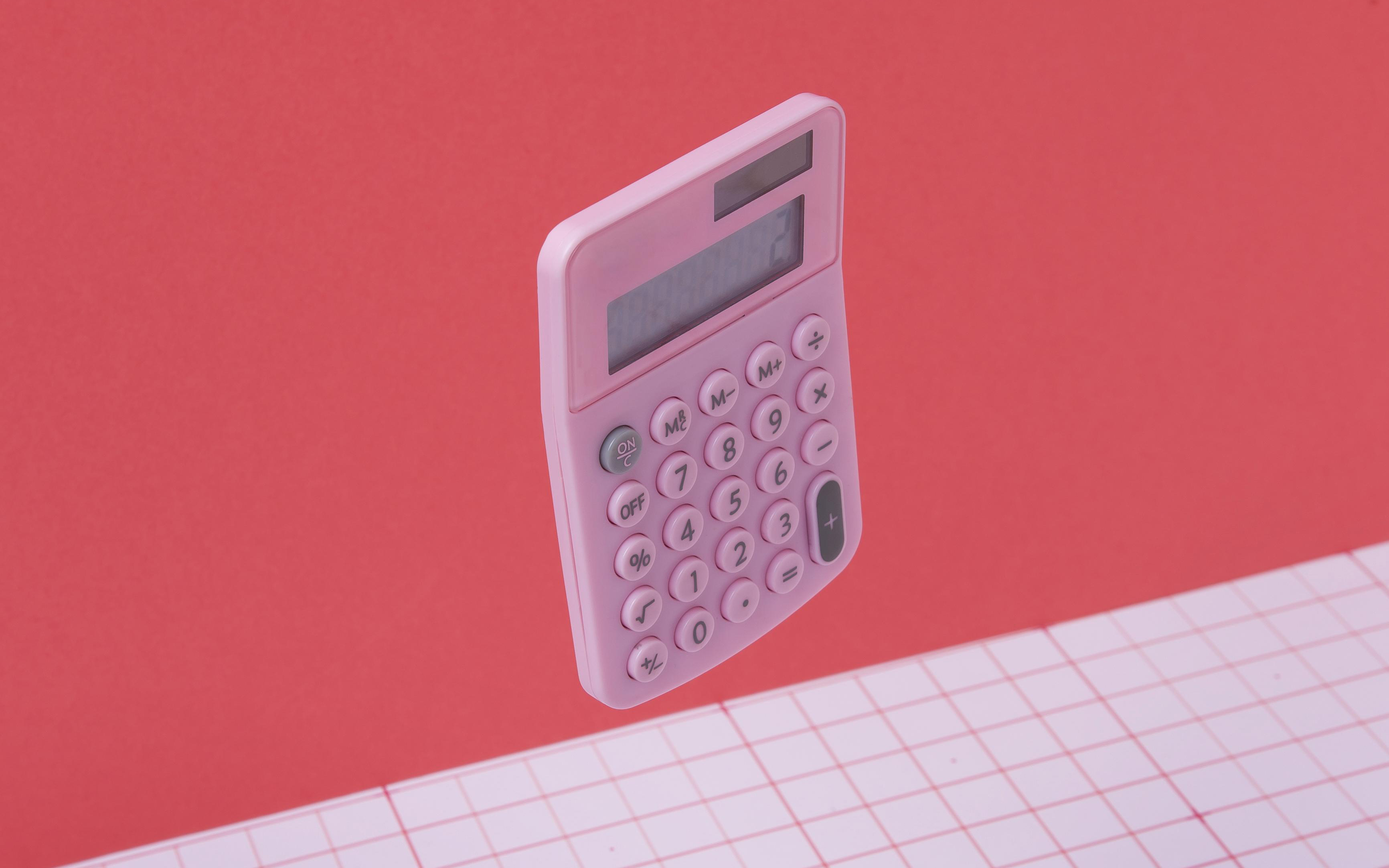 ink calculator on a coral background — calculating the cost of massage for employees in Australia