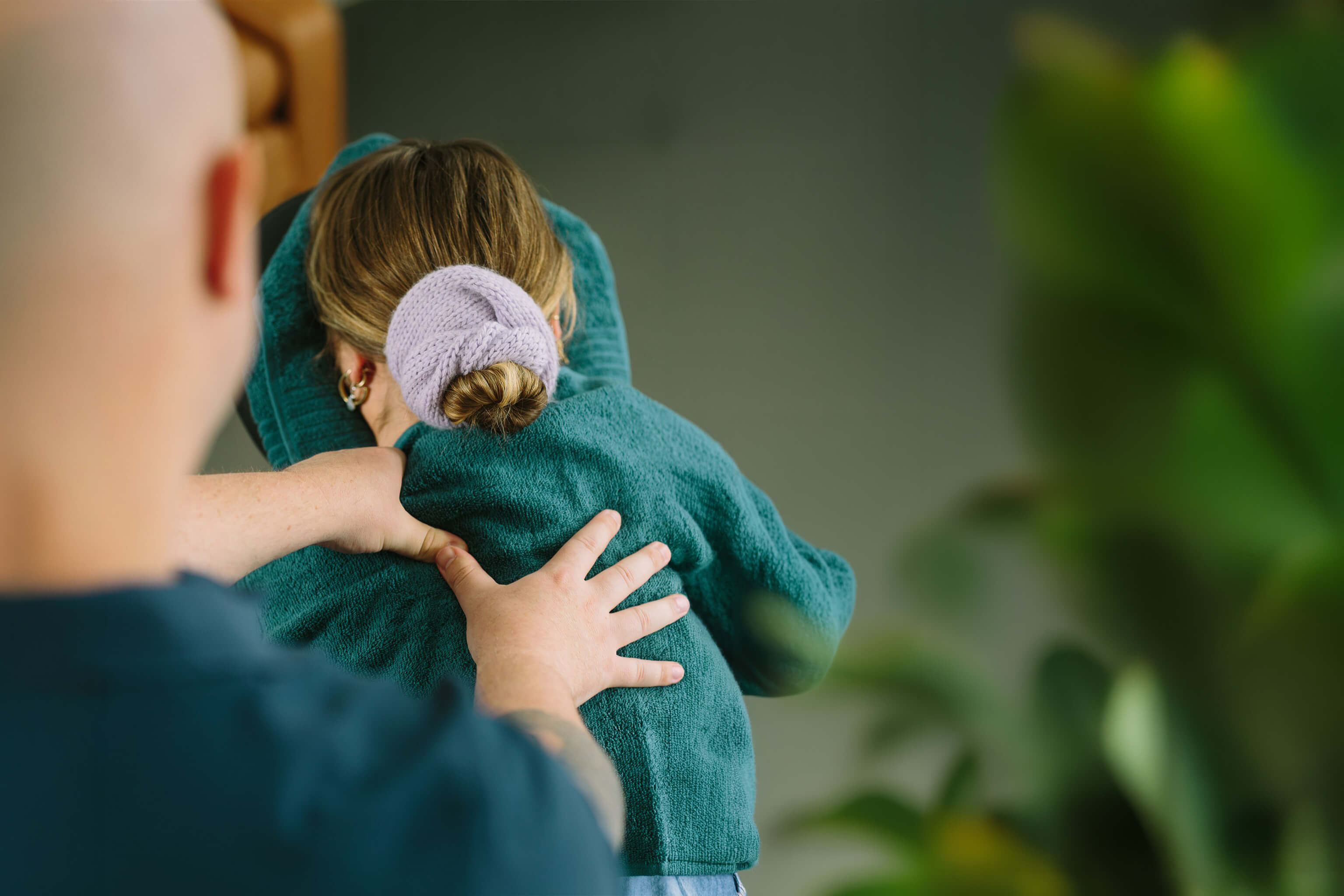 Corporate Calm therapist working on a desk worker's upper back during a workplace massage session