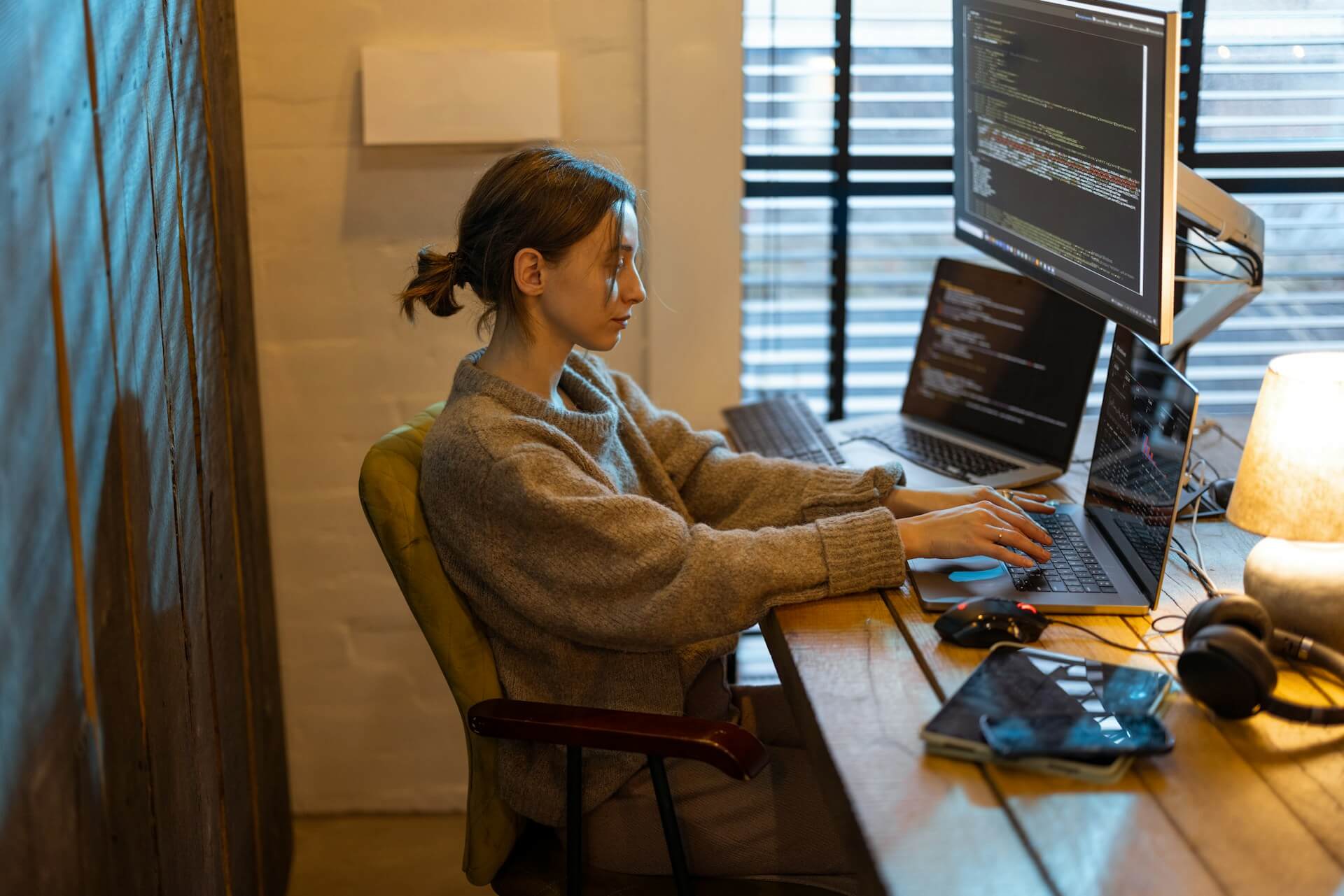 Female software developer working on code at her desk in a tech company office