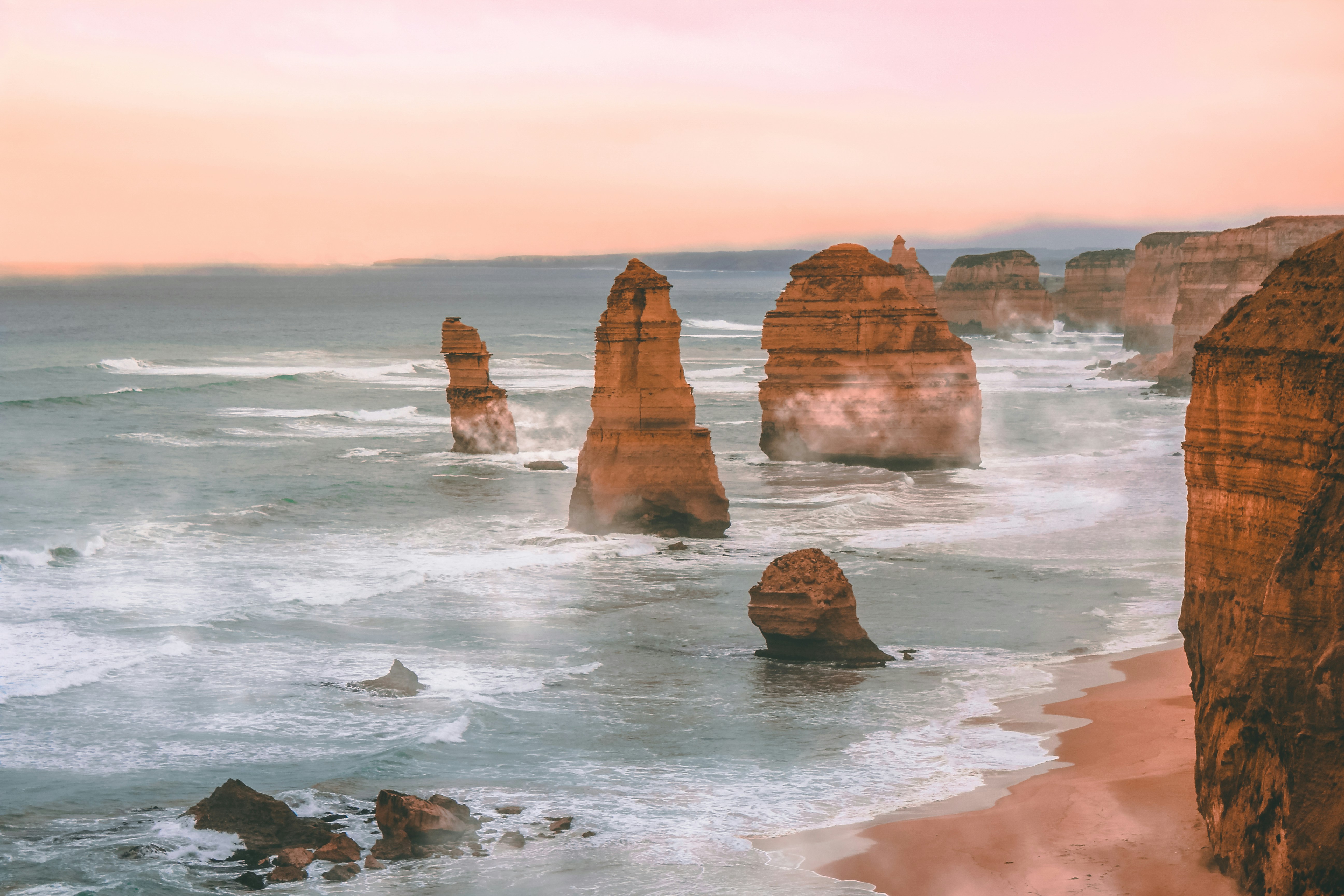 A collection of photographs showcasing Australia's contrasting environments: the Red Desert, tropical reefs, and pristine coastlines.