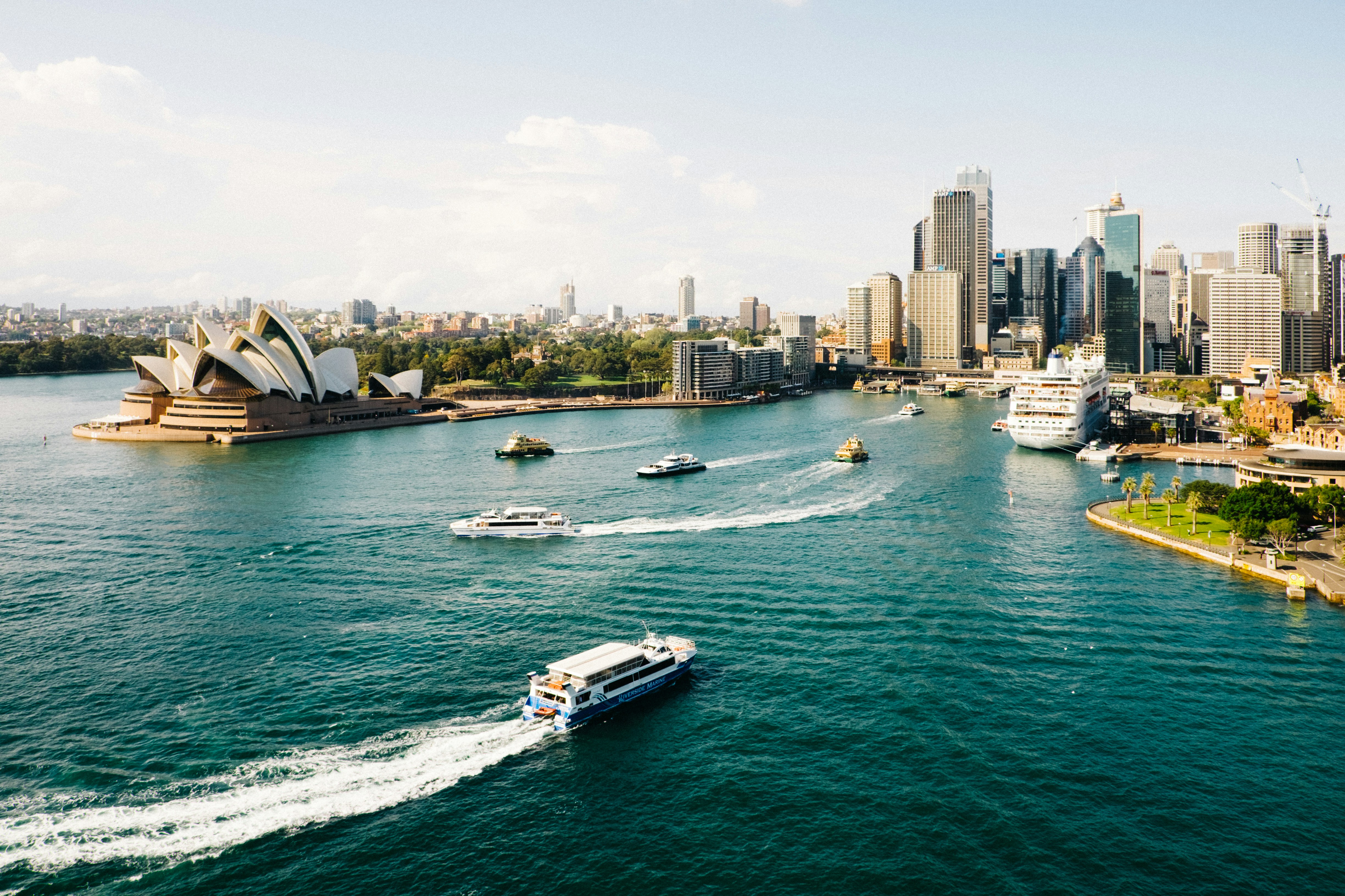 Iconic view of Sydney Harbour, featuring the Opera House and Harbour Bridge, symbolizing the start of the Classic Australia Highlights journey.